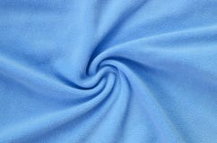 The blanket of furry blue fleece fabric. A background of light blue soft plush fleece material with a lot of relief folds. stock photography The blanket of furry blue fleece fabric. A background of light blue soft plush fleece material with a lot of relief folds. stock photography