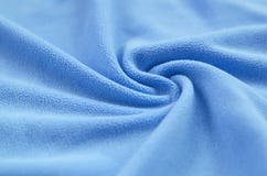 The blanket of furry blue fleece fabric. A background of light blue soft plush fleece material with a lot of relief folds. royalty free stock images The blanket of furry blue fleece fabric. A background of light blue soft plush fleece material with a lot of relief folds. royalty free stock images