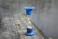 Blauer Stand der alten Sanduhr auf dem Tisch stockfotografie Blauer Stand der alten Sanduhr auf dem Tisch stockfotografie