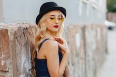 Blond attractive girl in sunglasses and stylish hat at summer sunshine urban stock photos Blond attractive girl in sunglasses and stylish hat at summer sunshine urban stock photos