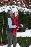 Blond teenager girl making a snowball in snowy back yard stock image Blond teenager girl making a snowball in snowy back yard stock image
