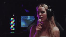 Blonde flirty gamer girl streamer licking a lollipop