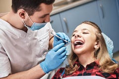 For a better looking tomorrow. Teen at the dental office. Dentist examining girl`s teeth in clinic. stock photos For a better looking tomorrow. Teen at the dental office. Dentist examining girl`s teeth in clinic. stock photos
