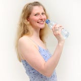 Blonde girl smiles while taking a drink of water royalty free stock photos Blonde girl smiles while taking a drink of water royalty free stock photos