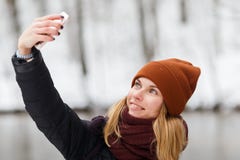 Blonde makes selfie in park stock photos Blonde makes selfie in park stock photos