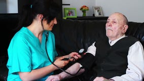 Blood pressure check to a senior man