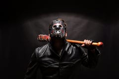 Bloody maniac in mask and black leather coat Royalty Free Stock Photos Bloody maniac in mask and black leather coat Royalty Free Stock Photos