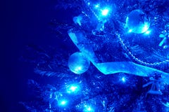 Blue background with christmas tree, ball, light.