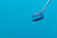 Dish washing brush on blue background stock photos Dish washing brush on blue background stock photos