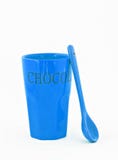 Blue glass with a spoon and the inscription isolated royalty free stock photography Blue glass with a spoon and the inscription isolated royalty free stock photography
