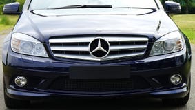 Blue mercedes Sedan Near Green Grass Field during Day Time Royalty Free Stock Photography Blue mercedes Sedan Near Green Grass Field during Day Time Royalty Free Stock Photography