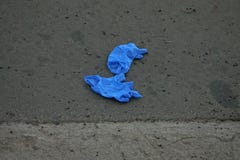Blue Nitrile Rubber Gloves Discarded on a Street