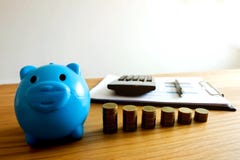 The blue piggy bank with business ,save money .finance concept . stock photo The blue piggy bank with business ,save money .finance concept . stock photo