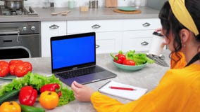 Blue screen laptop: Woman study online cooking course listen chef drink coffee