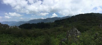 Blue sky, empty mountains, mountains in the distance, green, and many white clouds in the sky royalty free stock photography Blue sky, empty mountains, mountains in the distance, green, and many white clouds in the sky royalty free stock photography