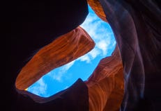Blue sky and white clouds as seen from within a slot canyon in Arizona