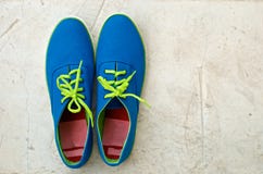 Blue Sneaker On Cement Floor Royalty Free Stock Photos