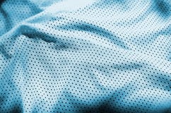 Blue sport clothing fabric texture background. Top view of light blue cloth textile surface. Bright basketball shirt. Text Spac