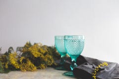 Blue Vintage Goblets and yellow mimosa flowers . Wineglasses on whight background stock photo Blue Vintage Goblets and yellow mimosa flowers . Wineglasses on whight background stock photo