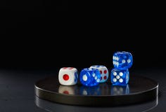 Blue and white dices on a round stone base stock photo Blue and white dices on a round stone base stock photo