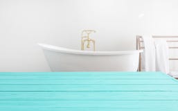 Blue Wooden Shelf And Towels On Bathroom Background. Wood Desk Table With Top View And Copy Space Near White Bath At Hotel. Room Stock Image Blue Wooden Shelf And Towels On Bathroom Background. Wood Desk Table With Top View And Copy Space Near White Bath At Hotel. Room Stock Image