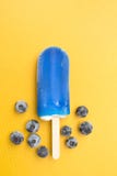Blueberry popsicle on yellow background Stock Photo Blueberry popsicle on yellow background Stock Photo