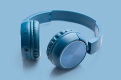 Bluetooth blue headphone on blue background stock image Bluetooth blue headphone on blue background stock image