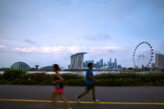 Blured people running in park at Marina Bay morning. Healthy lifestyle Royalty Free Stock Images Blured people running in park at Marina Bay morning. Healthy lifestyle Royalty Free Stock Images