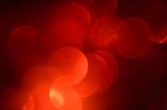 Blurred, bokeh red lights background. Abstract sparkles