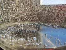 Air bubbles in the fresh boiling water with bokeh blur stock photography Air bubbles in the fresh boiling water with bokeh blur stock photography