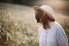 Blurred image of stylish girl in rustic dress smiling and waving hair in sunny meadow in mountains. Portrait of happy boho woman royalty free stock images Blurred image of stylish girl in rustic dress smiling and waving hair in sunny meadow in mountains. Portrait of happy boho woman royalty free stock images