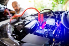 Blurry of male mechanic changing car battery, mechanic engineer fixing car battery with delivery service on road or home royalty free stock image Blurry of male mechanic changing car battery, mechanic engineer fixing car battery with delivery service on road or home royalty free stock image