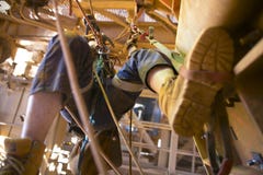 Blurry picture of rope access miner working at height hangin on two rope commencing ascending using foot loop step by step stock photography Blurry picture of rope access miner working at height hangin on two rope commencing ascending using foot loop step by step stock photography