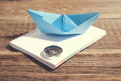 Boat and compass on notepad on wooden background royalty free stock images Boat and compass on notepad on wooden background royalty free stock images