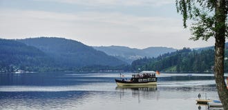 Boat cruising on Black Forest lake Titisee - Germany stock images Boat cruising on Black Forest lake Titisee - Germany stock images