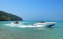 Boat Rides Tourists On An Inflatable Banana On The Coast Of Thailand Stock Images