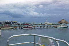 Boats are moored to several docks in Ambergris Caye as rain clouds gather in the background. stock image Boats are moored to several docks in Ambergris Caye as rain clouds gather in the background. stock image
