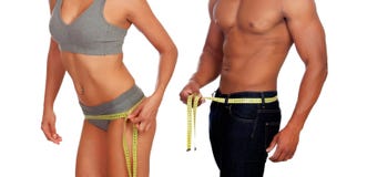 Bodies of man and woman measuring the waist with tape measure royalty free stock images Bodies of man and woman measuring the waist with tape measure royalty free stock images