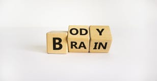 Body vs brain symbol. Turned wooden cubes and changed words `body` to `brain`. Beautiful white background, copy space. Busines