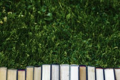 Book closed books are on the green grass royalty free stock photography Book closed books are on the green grass royalty free stock photography