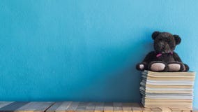 Books on table top with blue wall stock photography Books on table top with blue wall stock photography