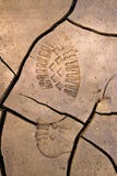 Bootprint in cracked earth stock photos Bootprint in cracked earth stock photos