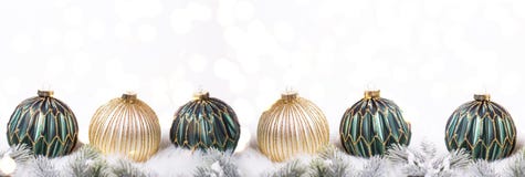 Border from green and golden balls and fir tree branches with bokeh lights stock photos Border from green and golden balls and fir tree branches with bokeh lights stock photos