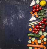 Border Vegetarian food concept tomatoes on a branch carrot cucumber lemon herbs. on wooden rustic background top view place for te Royalty Free Stock Photos Border Vegetarian food concept tomatoes on a branch carrot cucumber lemon herbs. on wooden rustic background top view place for te Royalty Free Stock Photos