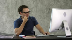 Bored young man at the desk in front of computer. stock photography Bored young man at the desk in front of computer. stock photography