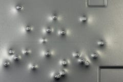 Bosselures des balles sur une surface métallique images libres de droits Bosselures des balles sur une surface métallique images libres de droits