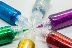 Botellas coloridas llenadas de pegamento del brillo imagenes de archivo Botellas coloridas llenadas de pegamento del brillo imagenes de archivo