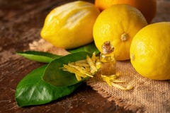 Bottiglie con olio essenziale della buccia e della foglia di limone su tabl di legno Fotografia Stock Libera da Diritti Bottiglie con olio essenziale della buccia e della foglia di limone su tabl di legno Fotografia Stock Libera da Diritti