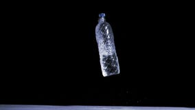 Bottle falling in super slow motion while filled with water