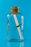 Bottle with message. Over a blue background stock images Bottle with message. Over a blue background stock images